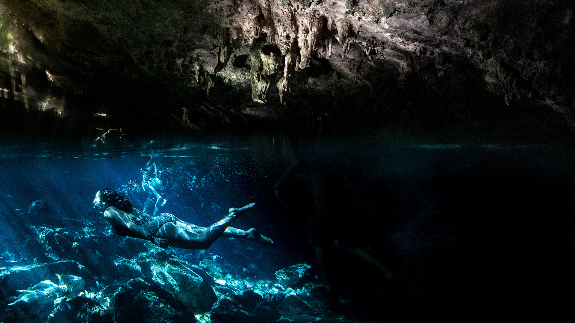 Writer Kassondra Cloos dives through the crystal-clear water at Cenote Dos Ojos.